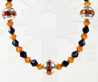 Orange and Black Bracelet with Silver Crystal Beads